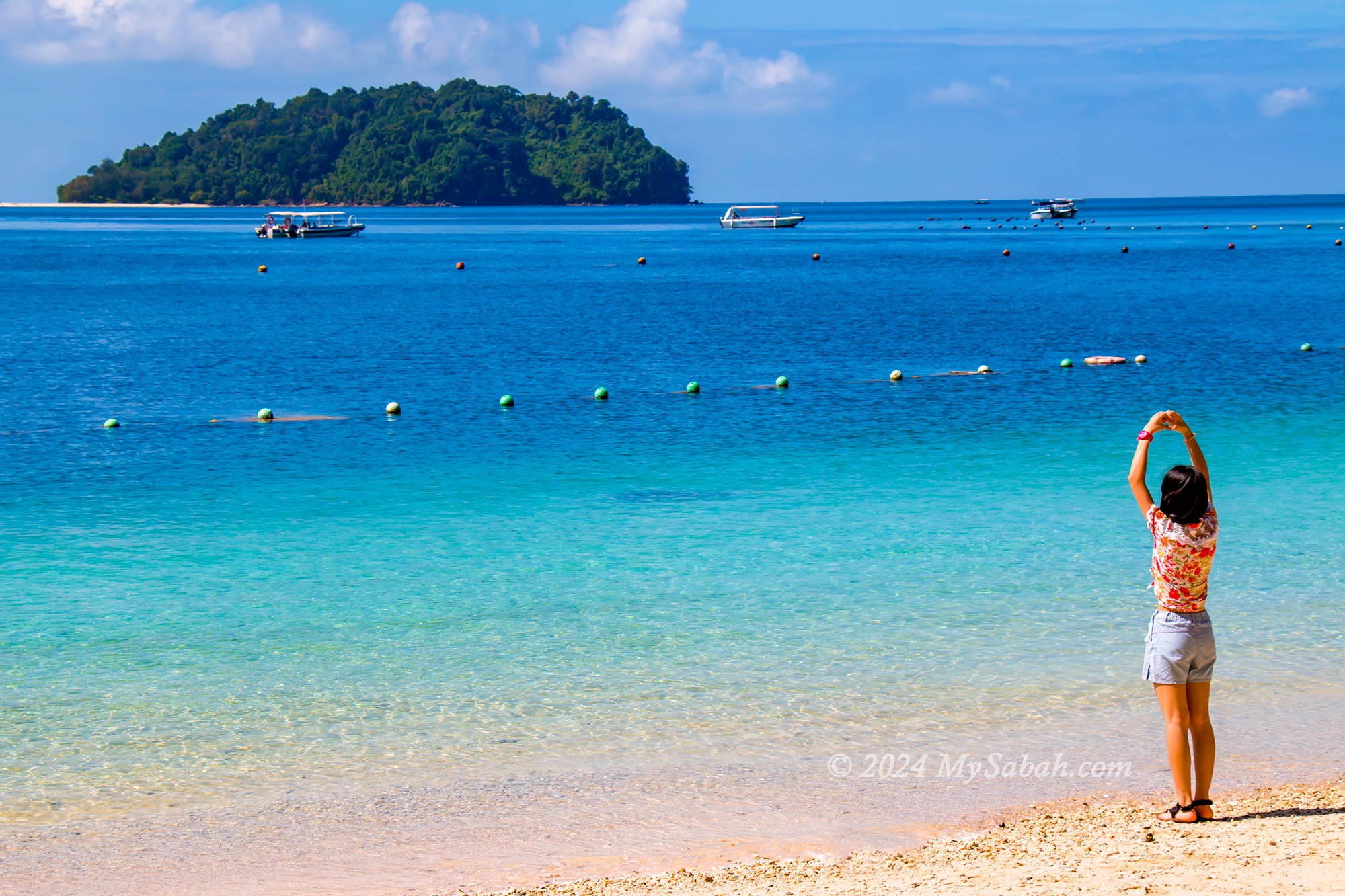 Girl standing on the beach of Manukan Island