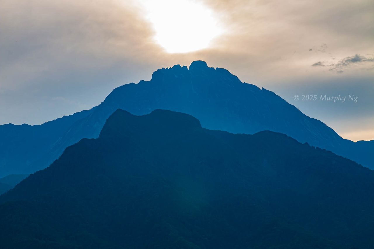 Sunrise behind Mount Kinabalu and Mount Nungkok (Anak Kinabalu)