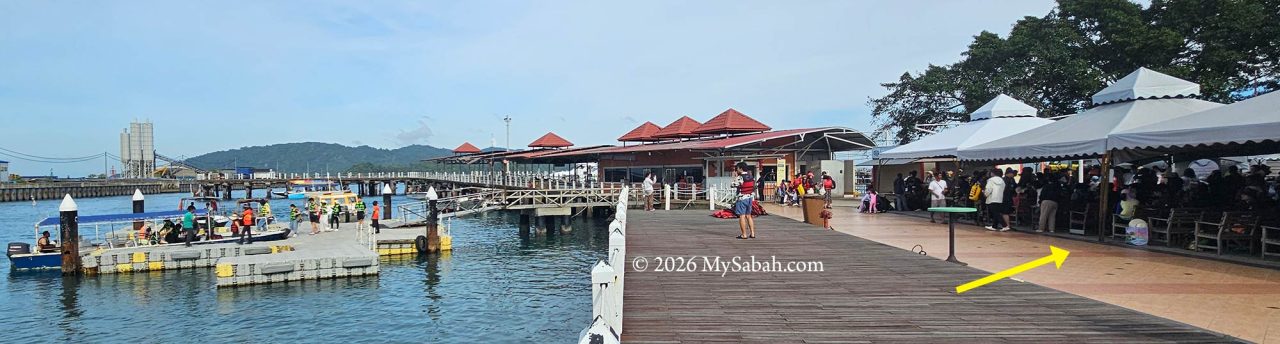 Outdoor food stalls under the canopy along the jetty walkway at Jesselton Point.